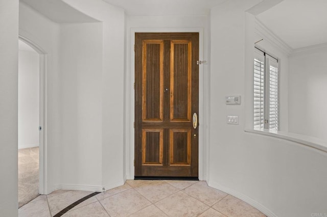 entryway featuring light tile patterned floors and baseboards