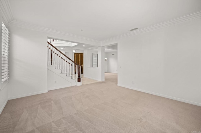 spare room featuring crown molding, visible vents, stairway, light carpet, and baseboards