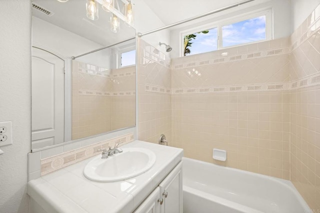 bathroom with visible vents, shower / tub combination, and vanity