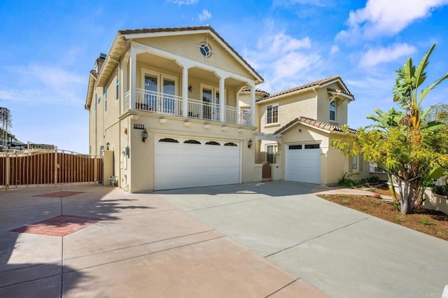 view of front of home featuring a garage, a balcony, and stucco siding