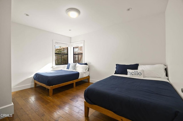 bedroom with baseboards and hardwood / wood-style floors