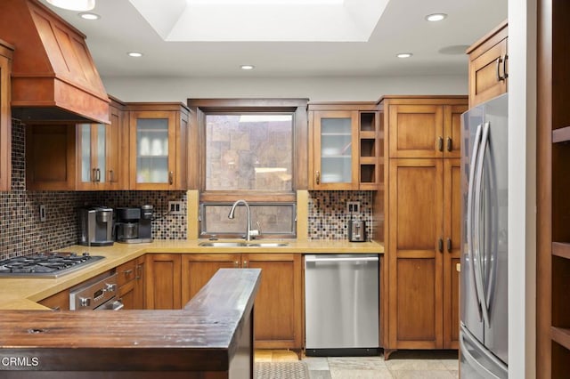 kitchen featuring stainless steel appliances, premium range hood, a sink, and light countertops