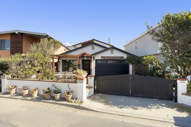 view of front facade with a garage, driveway, and fence