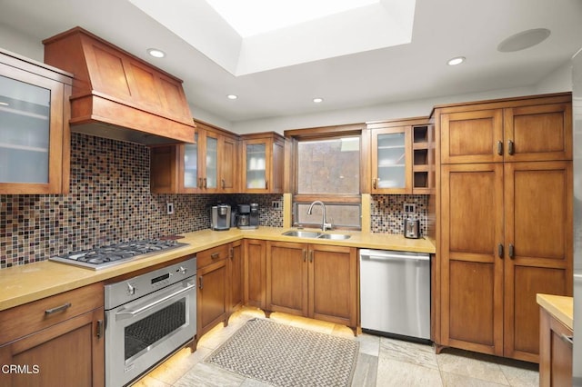 kitchen with stainless steel appliances, light countertops, a sink, and custom exhaust hood