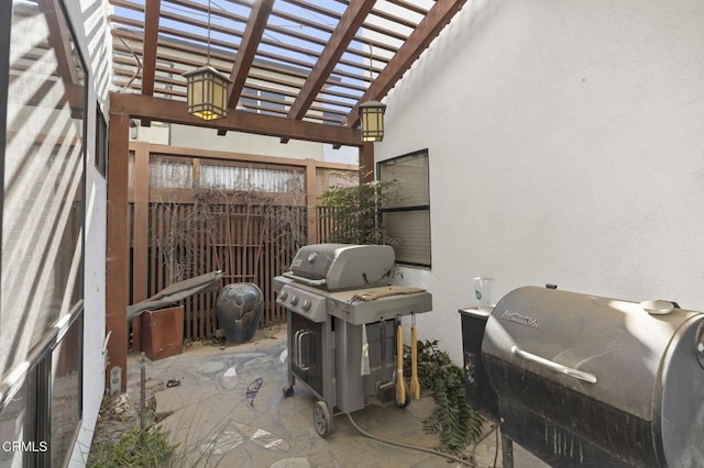 view of patio with fence, a pergola, and area for grilling