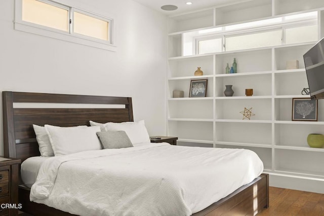 bedroom with recessed lighting and wood finished floors