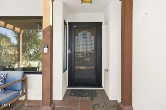 property entrance with stucco siding