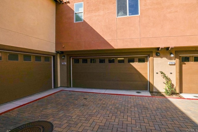 garage with decorative driveway