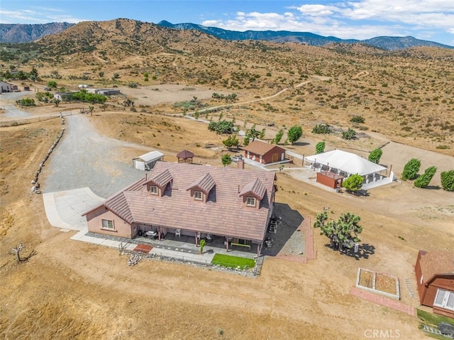 birds eye view of property featuring a mountain view and a desert view