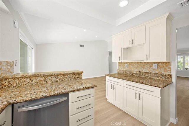 kitchen with tasteful backsplash, visible vents, vaulted ceiling, and dishwasher