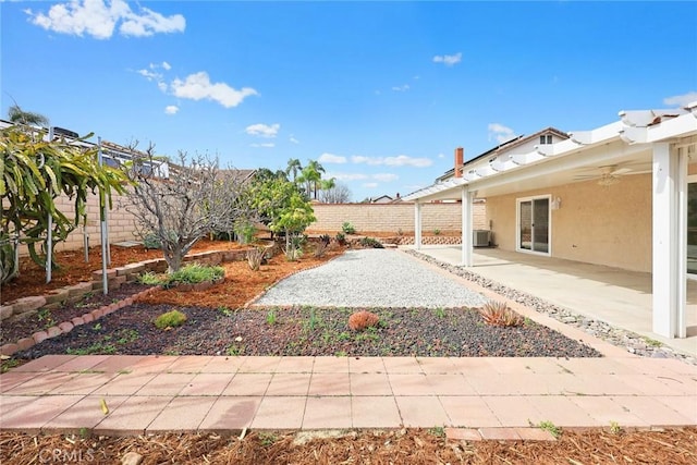 view of yard featuring a patio area, a fenced backyard, a ceiling fan, and central air condition unit