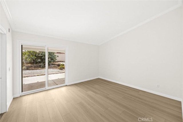 unfurnished room with crown molding, light wood-type flooring, and baseboards