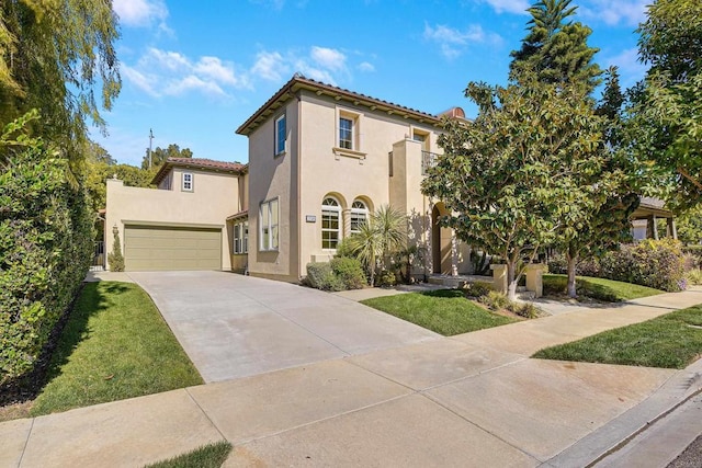 mediterranean / spanish home featuring driveway, stucco siding, a front lawn, a garage, and a tile roof