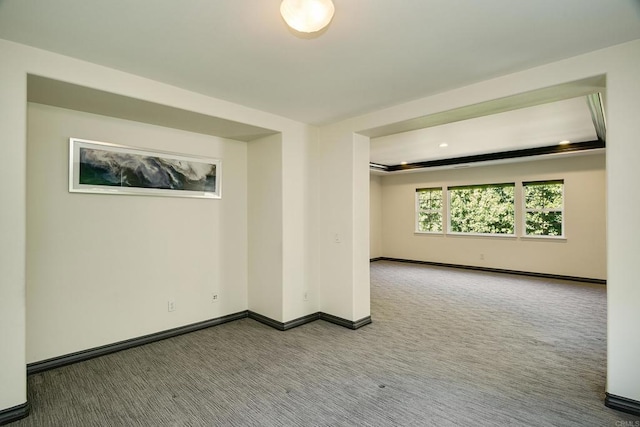 unfurnished room featuring baseboards and carpet flooring