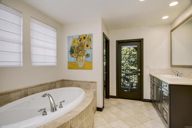 full bath with tile patterned floors, baseboards, recessed lighting, a bath, and vanity