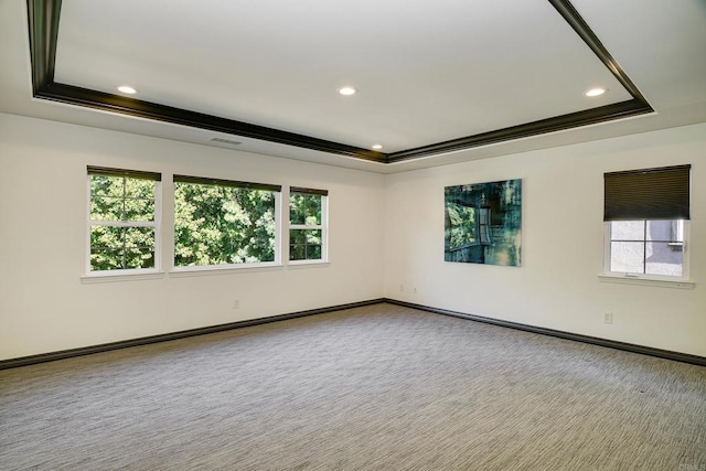 empty room featuring visible vents, recessed lighting, a tray ceiling, and carpet floors