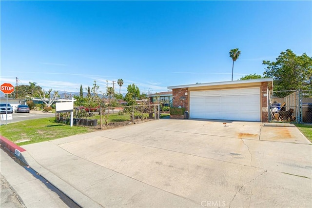 exterior space featuring a garage, fence, and brick siding