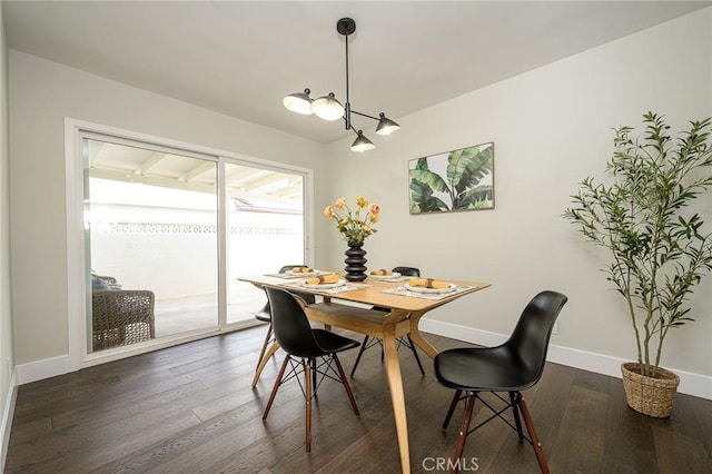 dining space featuring baseboards and dark wood finished floors