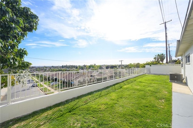 view of yard with central AC unit and fence