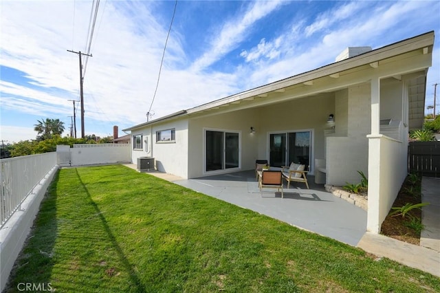 back of house featuring a fenced backyard, central air condition unit, a lawn, stucco siding, and a patio area