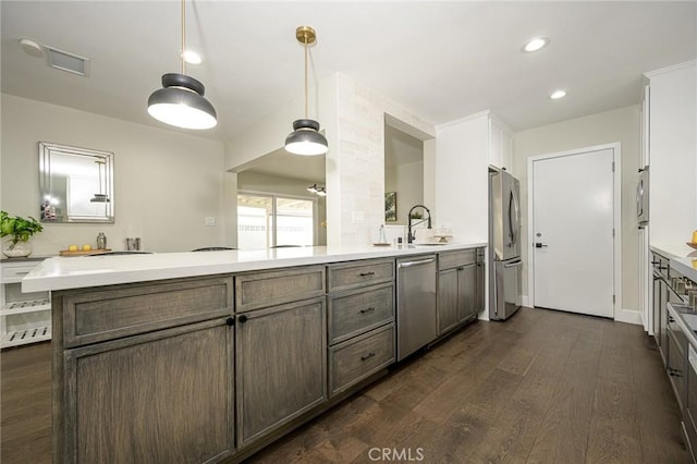 bathroom with double vanity, visible vents, wood finished floors, a sink, and recessed lighting