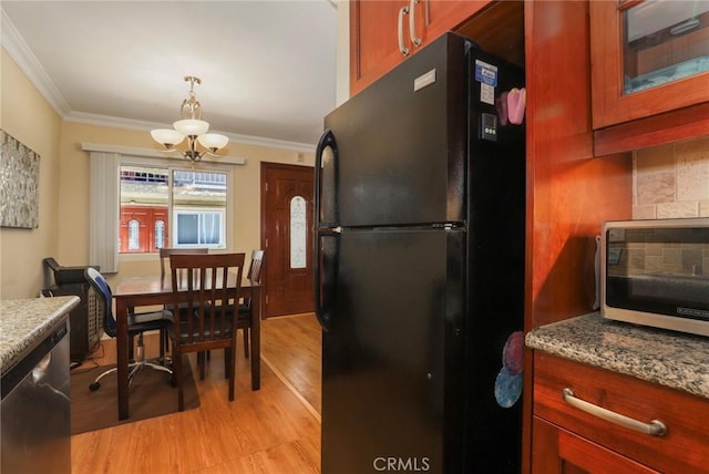 kitchen with light wood finished floors, dishwasher, freestanding refrigerator, crown molding, and backsplash