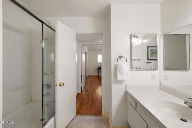 full bathroom featuring enclosed tub / shower combo, vanity, and tile patterned floors