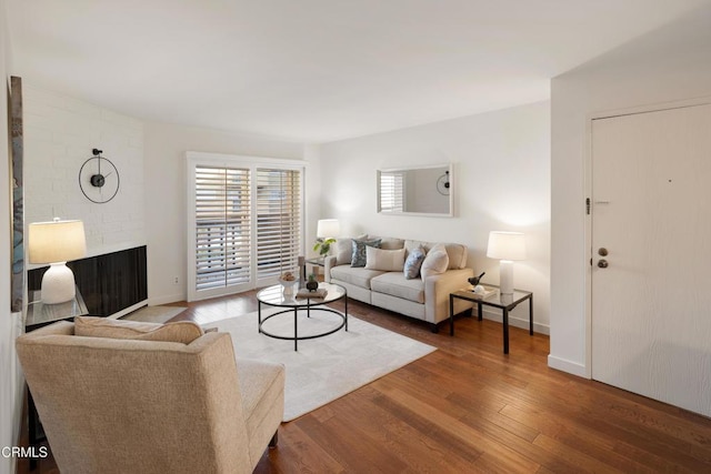 living room with dark wood-type flooring and baseboards