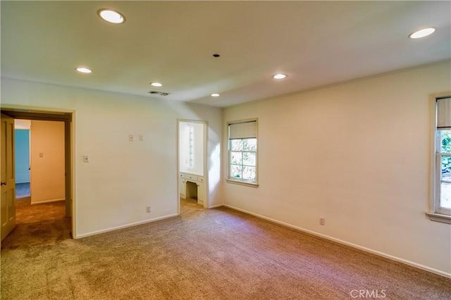 empty room with carpet, visible vents, baseboards, and recessed lighting