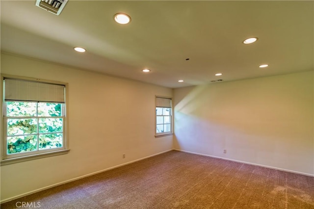 unfurnished room featuring carpet, visible vents, and recessed lighting