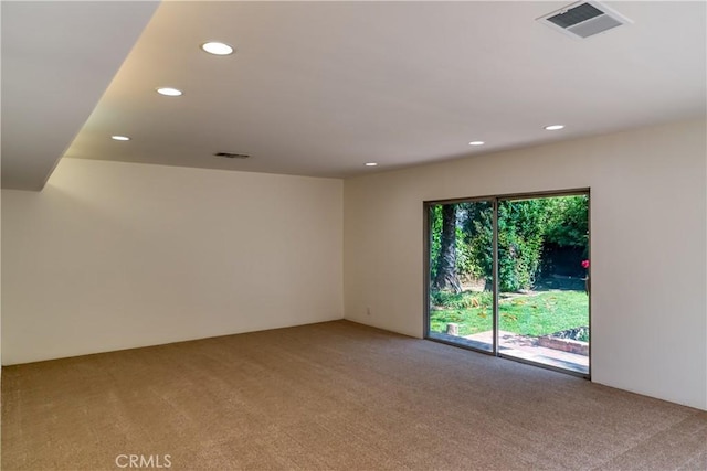 unfurnished room featuring light colored carpet, visible vents, and recessed lighting