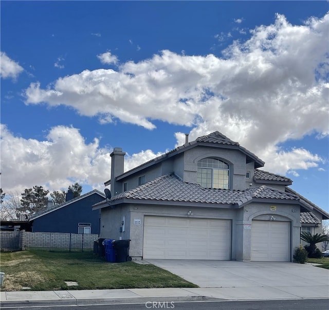 view of front of house featuring a tile roof, fence, concrete driveway, stucco siding, and a front lawn