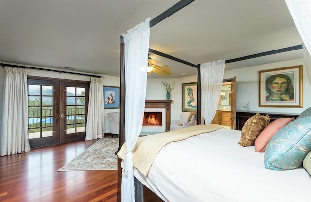 420 Inverness Dr, La Canada Flintridge, CA 91011 - bedroom with french doors, access to exterior, wood finished floors, a warm lit fireplace, and connected bathroom