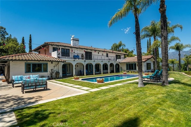 420 Inverness Dr, La Canada Flintridge, CA 91011 - back of property featuring a balcony, a patio, an outdoor pool, an outdoor hangout area, and a tiled roof