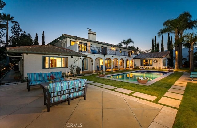 420 Inverness Dr, La Canada Flintridge, CA 91011 - back of property with a balcony, stucco siding, a chimney, an outdoor hangout area, and a patio area