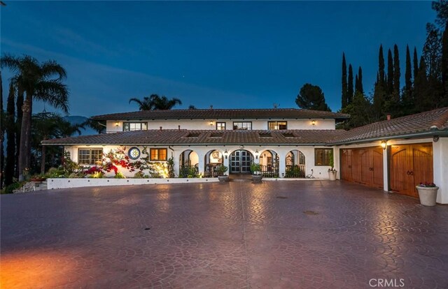 420 Inverness Dr, La Canada Flintridge, CA 91011 - mediterranean / spanish home with curved driveway, an attached garage, and stucco siding