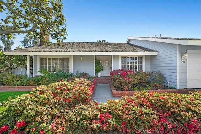 single story home with an attached garage and a chimney