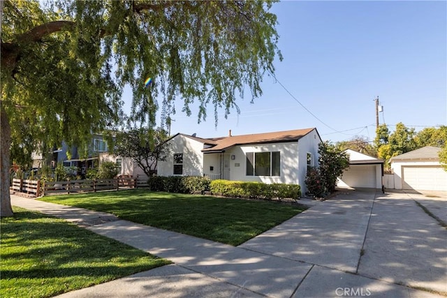 view of front of property featuring a garage, stucco siding, an outdoor structure, and a front yard