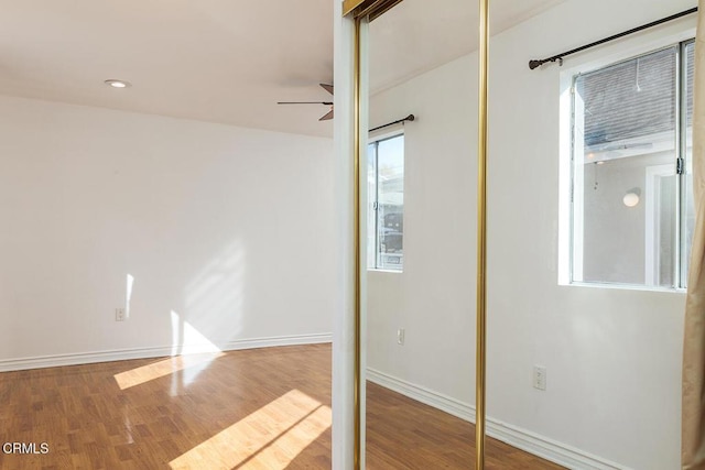 interior space featuring a closet, recessed lighting, wood finished floors, and baseboards