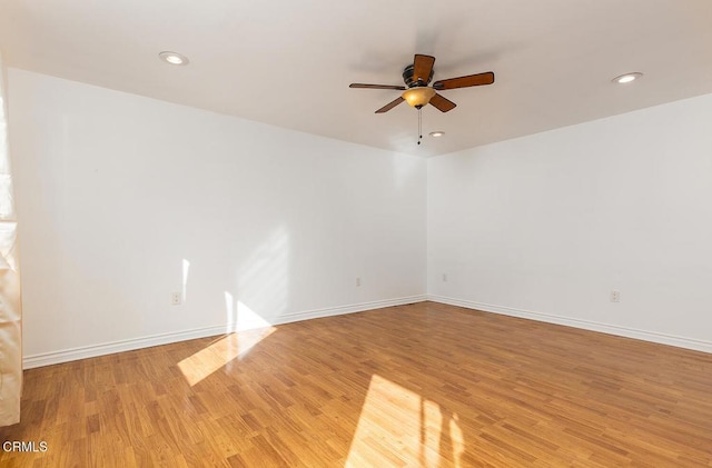 unfurnished room featuring recessed lighting, light wood-type flooring, a ceiling fan, and baseboards