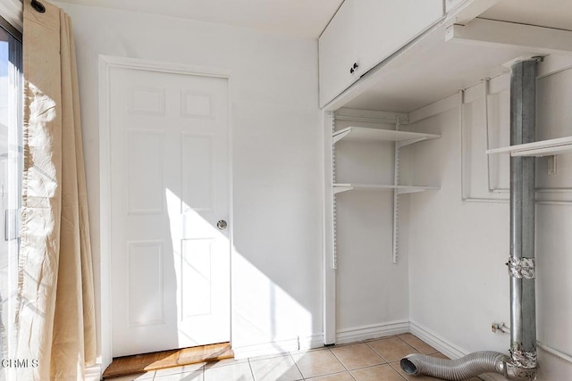 spacious closet featuring light tile patterned floors