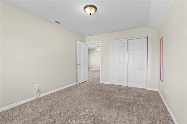 unfurnished bedroom with visible vents, baseboards, carpet flooring, and a closet