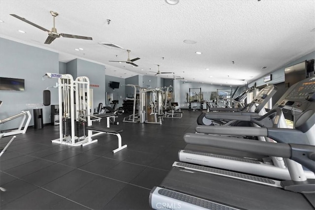 workout area with a textured ceiling, visible vents, and a ceiling fan