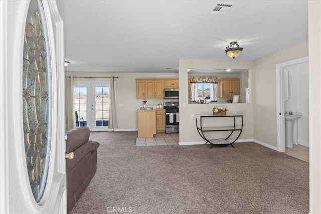 living area with baseboards, visible vents, light carpet, and french doors