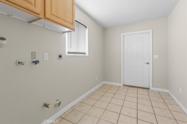 laundry room with gas dryer hookup, light tile patterned flooring, cabinet space, and baseboards