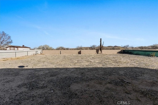view of yard featuring fence and a rural view