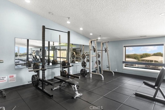 exercise room with a textured ceiling, recessed lighting, and baseboards