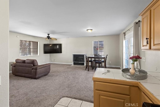 living room with ceiling fan and light colored carpet