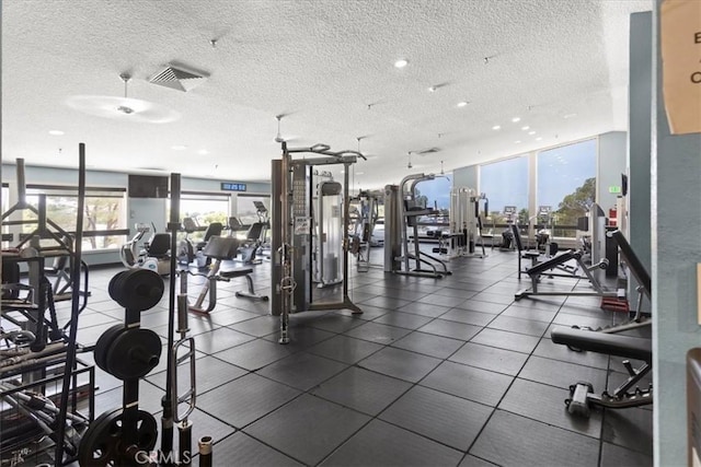 exercise room featuring a textured ceiling and visible vents
