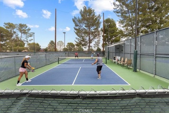 view of sport court featuring fence